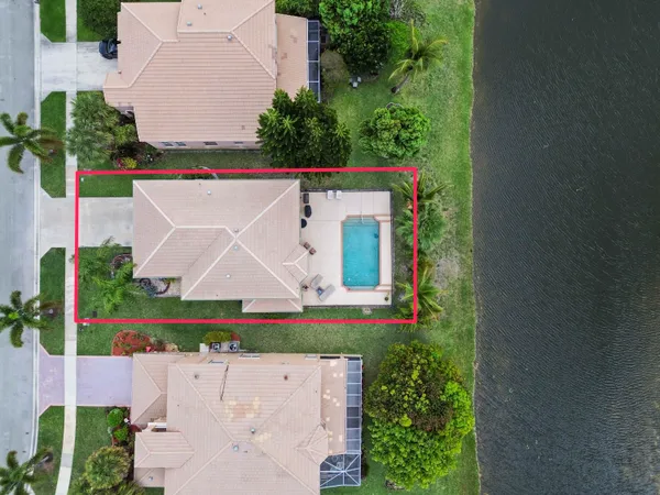 an aerial view of a house with a yard