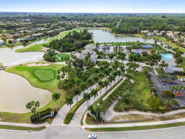 an aerial view of residential houses with outdoor space and swimming pool