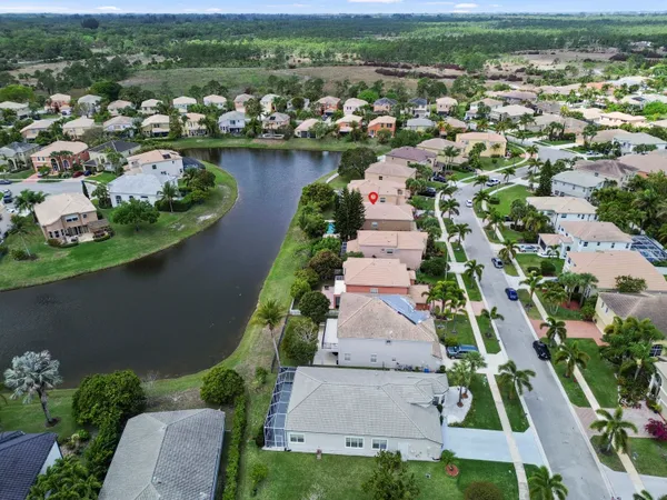 an aerial view of a house with a garden and lake view