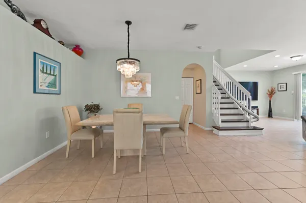 a view of a dining room with furniture and stairs