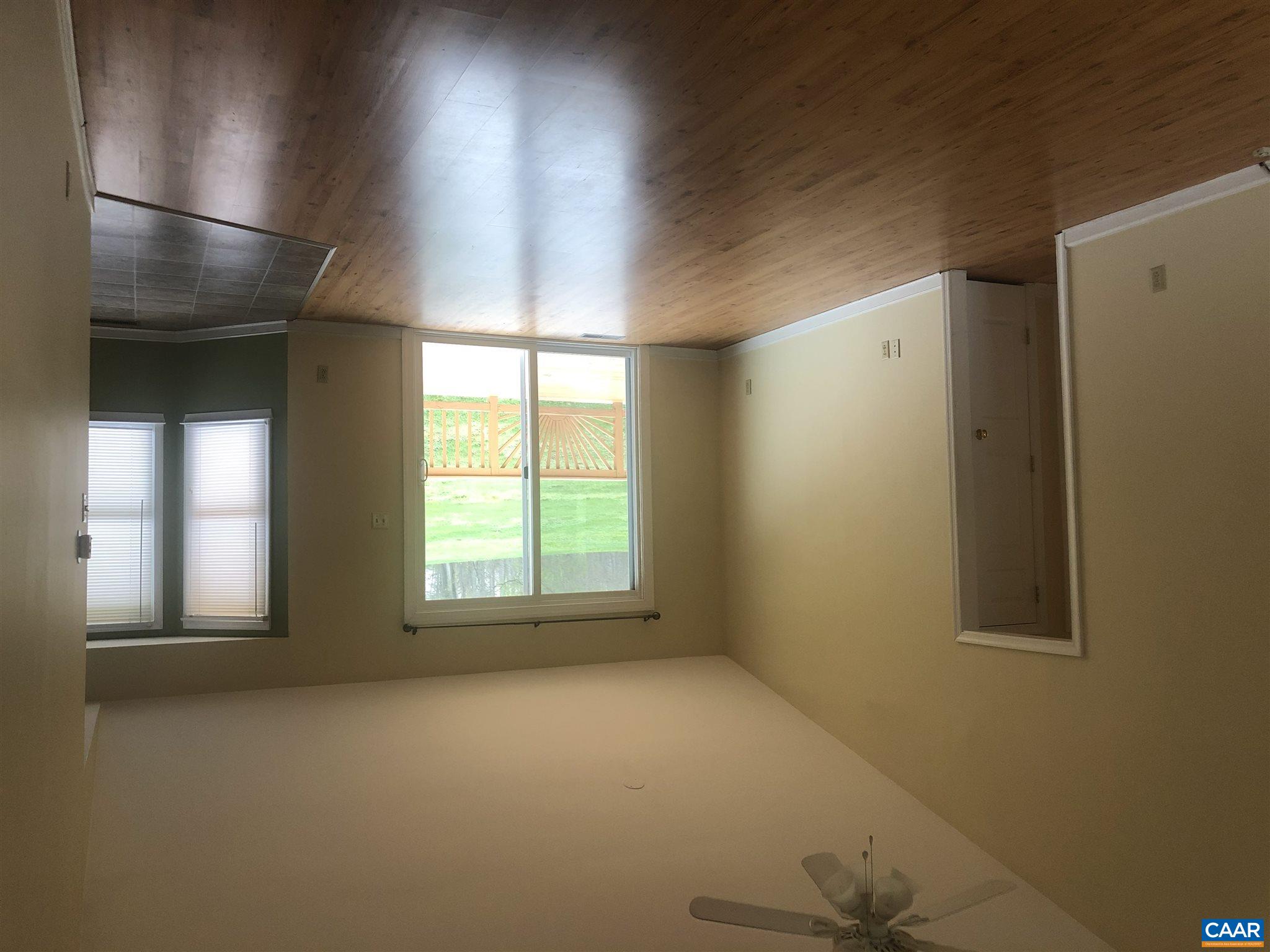 2811 Amicus Road Stanardsville, VA 22973 - Photo 11 of 27 an empty room with wooden floor and windows
