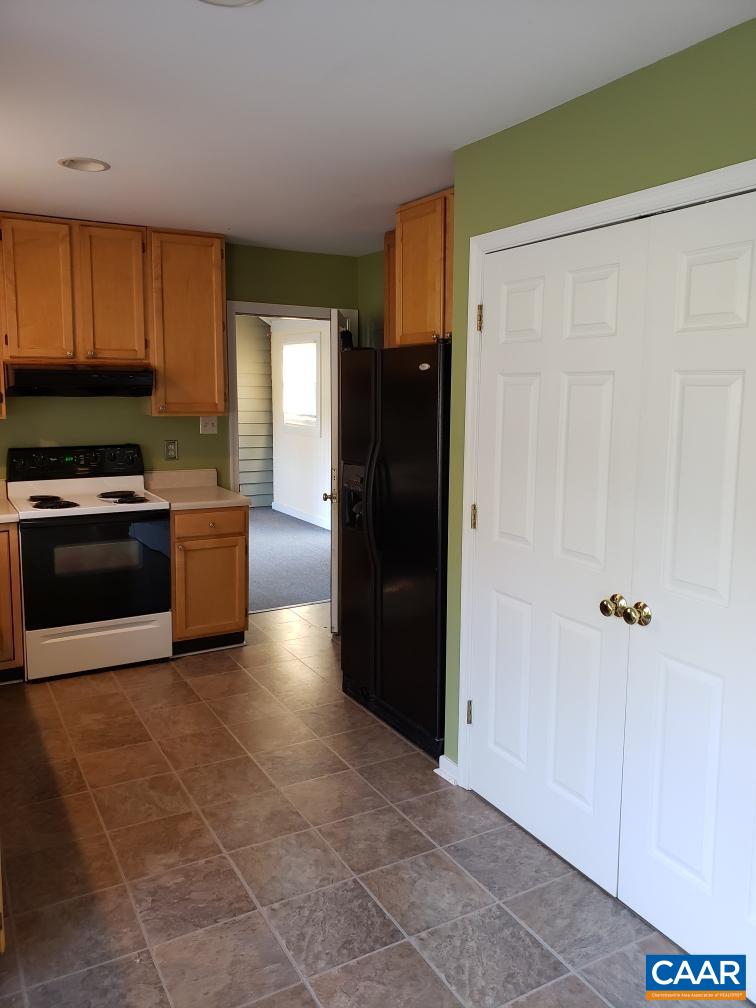 2811 Amicus Road Stanardsville, VA 22973 - Photo 5 of 27 a kitchen with a refrigerator and a stove top oven