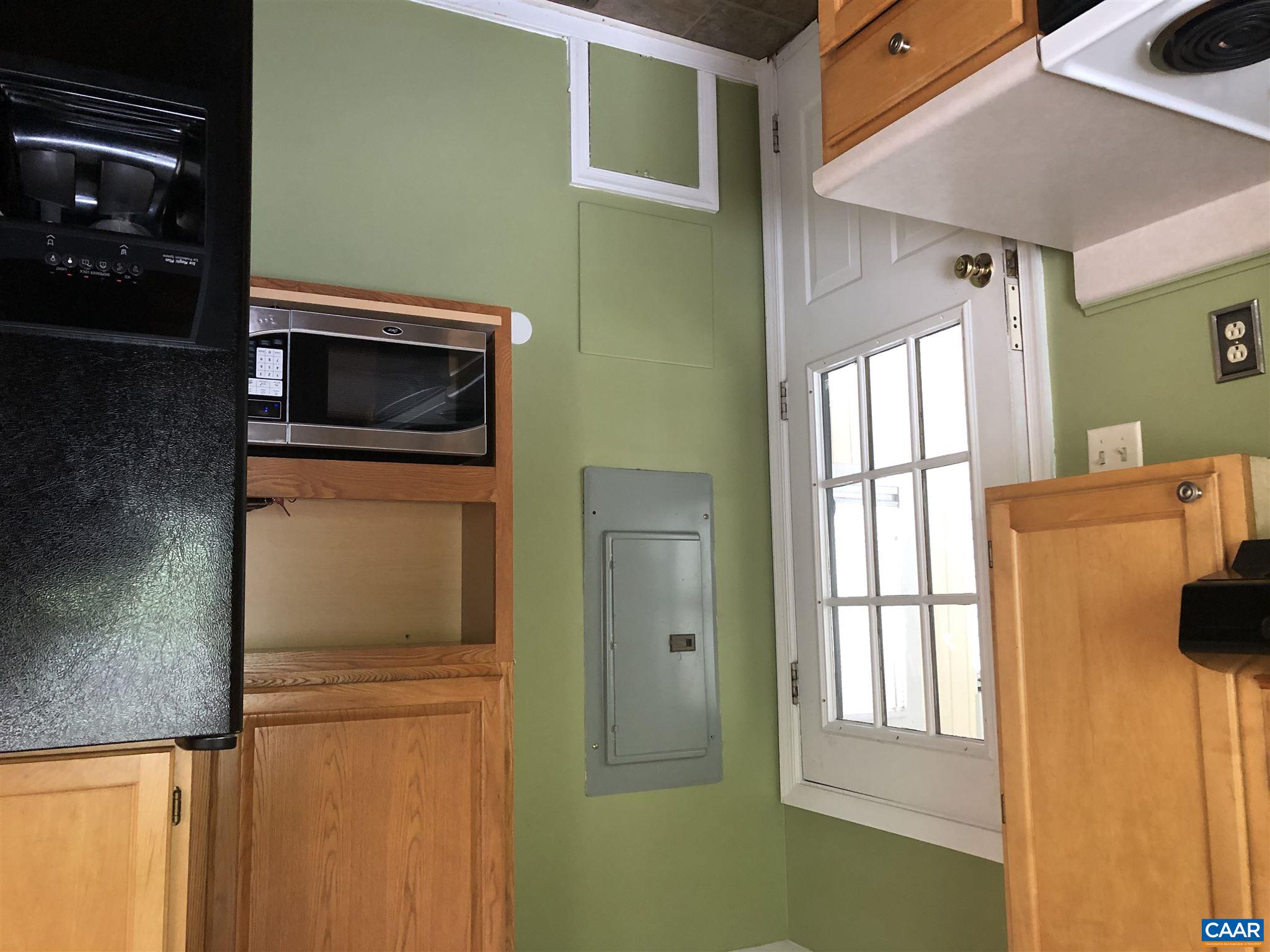 2811 Amicus Road Stanardsville, VA 22973 - Photo 6 of 27 a kitchen with a refrigerator and a stove top oven
