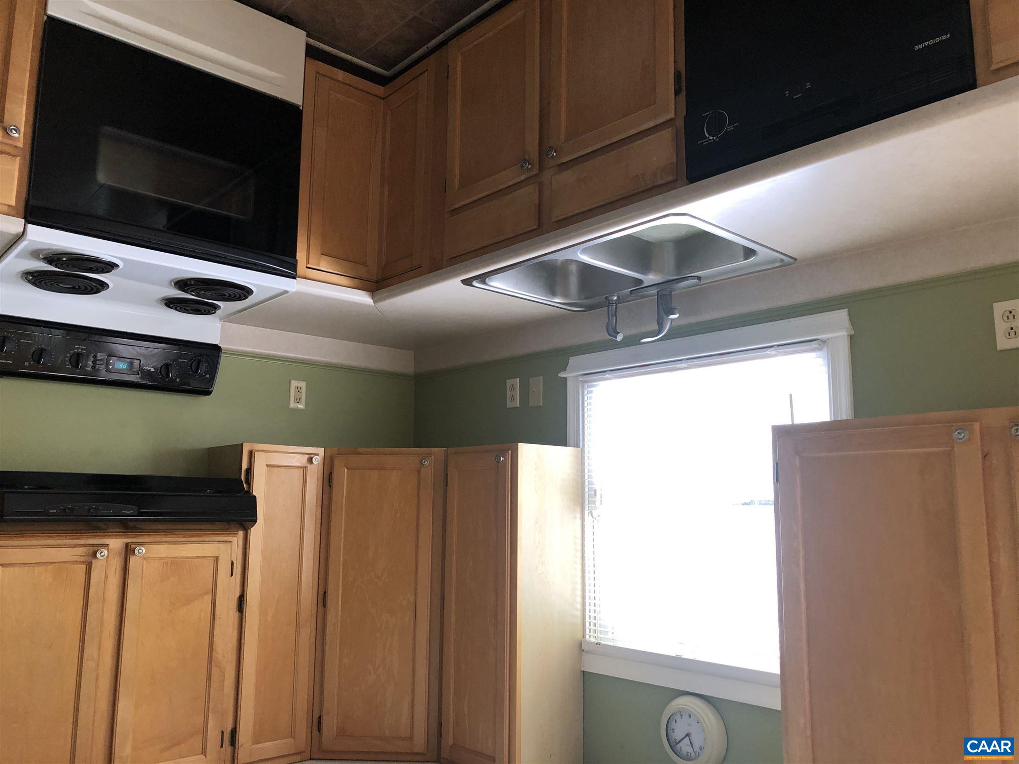 2811 Amicus Road Stanardsville, VA 22973 - Photo 7 of 27 a kitchen with stainless steel appliances granite countertop a sink a stove and a microwave