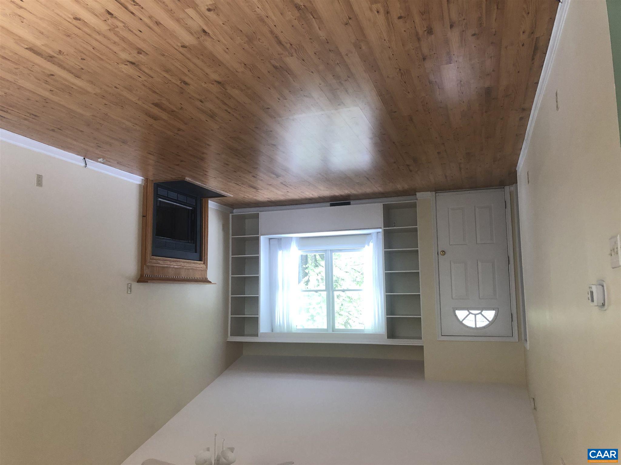 2811 Amicus Road Stanardsville, VA 22973 - Photo 10 of 27 an empty room with wooden floor fireplace and windows