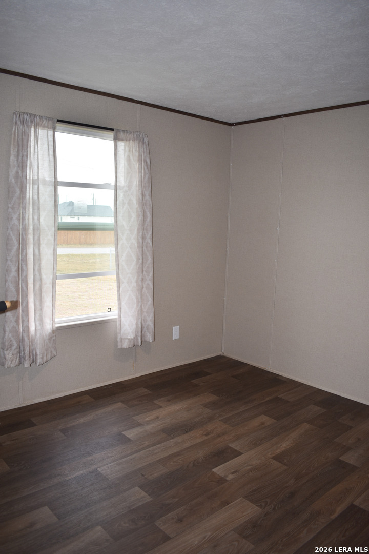 17016 Rancho Escondido Atascosa, TX 78002 - Photo 11 of 14 a view of a room with wooden floor and a window