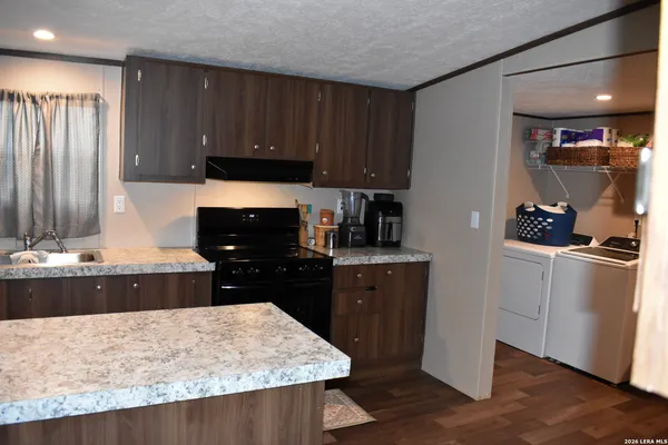 a kitchen with a refrigerator and a stove