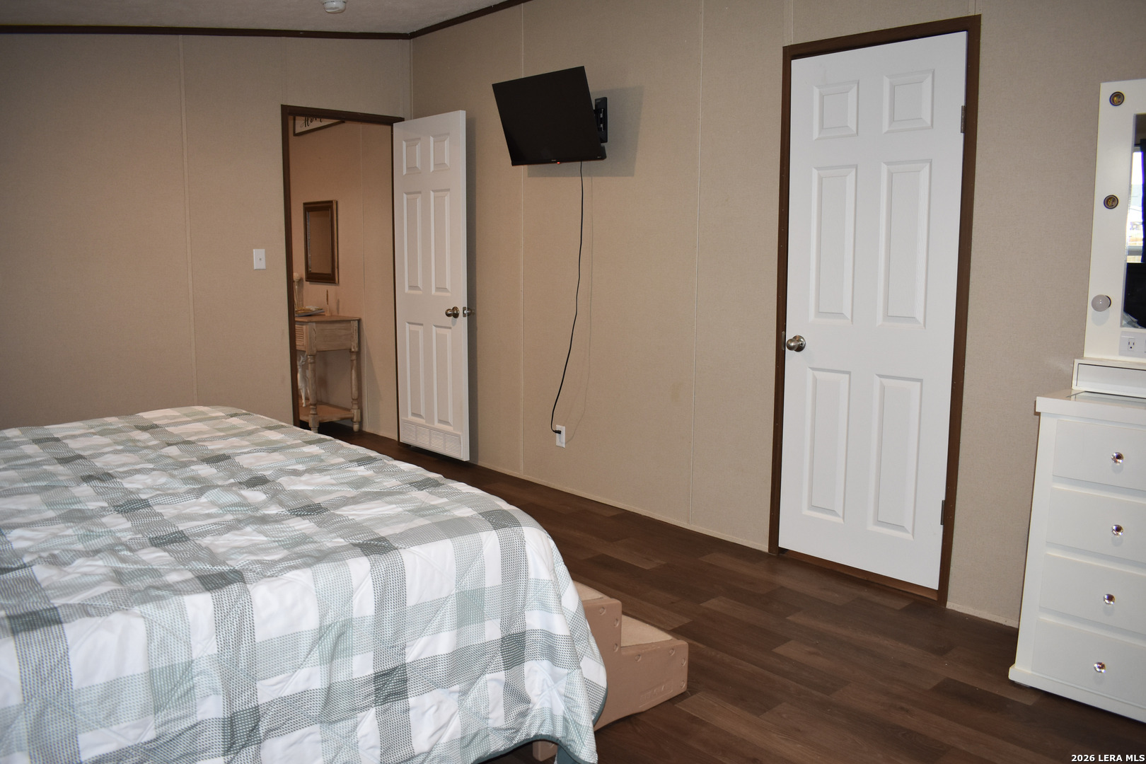 17016 Rancho Escondido Atascosa, TX 78002 - Photo 7 of 14 a bedroom with a bed and a flat tv screen on the dresser