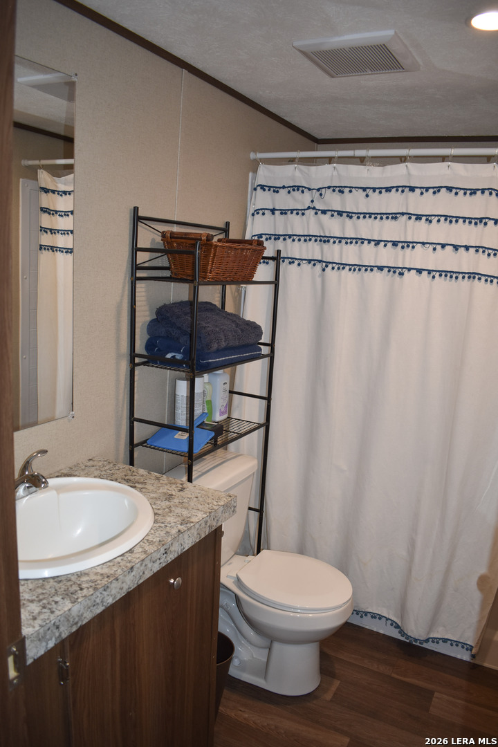 17016 Rancho Escondido Atascosa, TX 78002 - Photo 10 of 14 a bathroom with a granite countertop sink toilet and shower