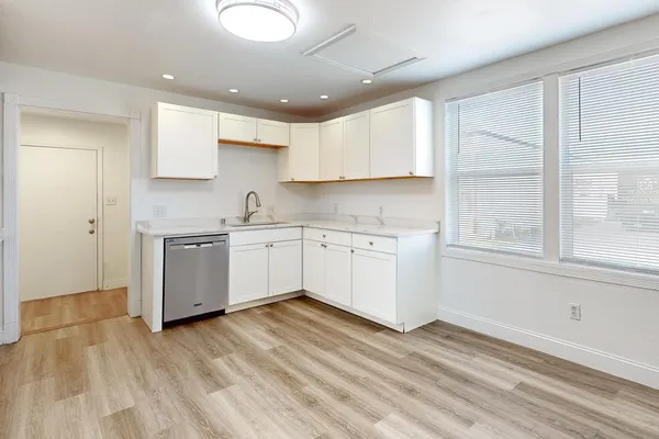a kitchen with a sink cabinets and window