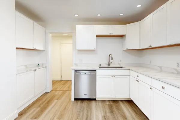 a kitchen with a sink a stove and cabinets