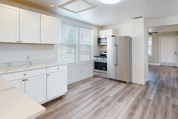 a kitchen with stainless steel appliances a refrigerator sink and cabinets