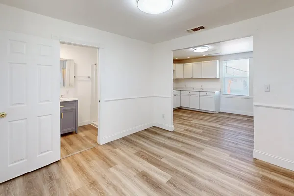 a view of a room with wooden floor