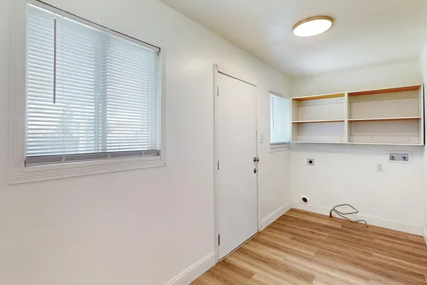 a view of a room with wooden floor and closet