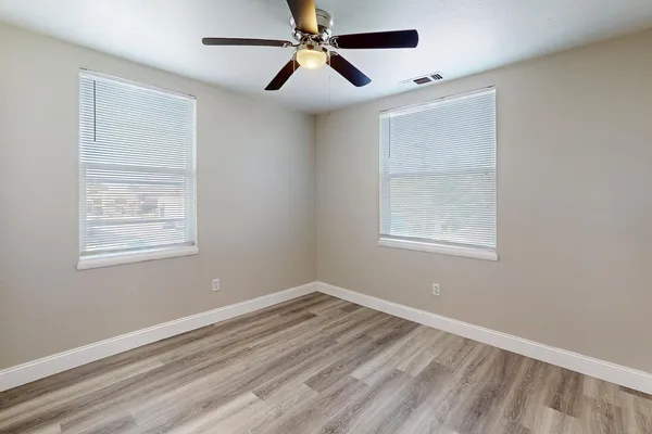 a view of room with a ceiling fan and window