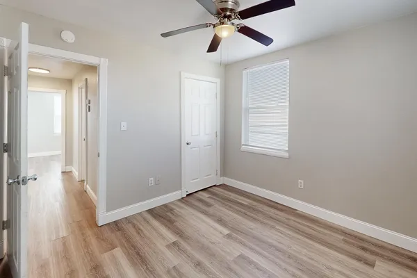 wooden floor in an empty room with a window