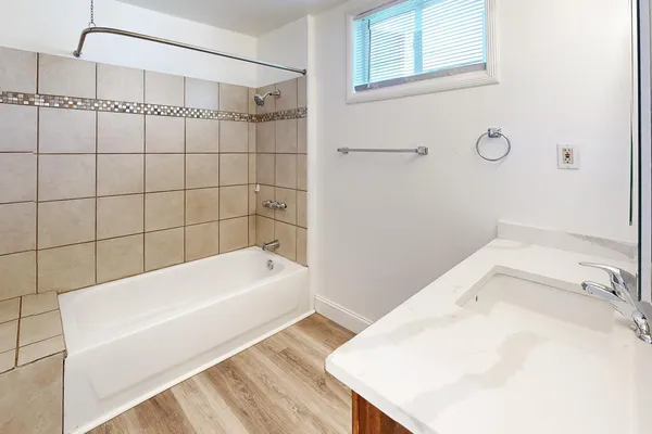 a bathroom with a bathtub and shower