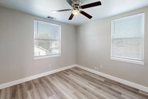 a view of room with window and ceiling fan