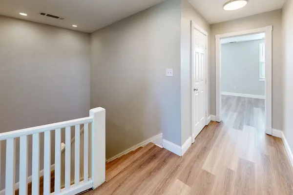a view of a room with wooden floor and closet