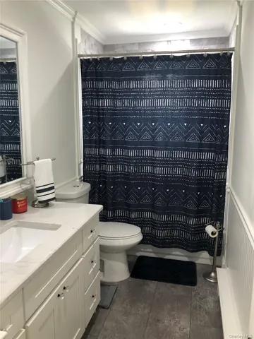 a bathroom with a toilet and a sink