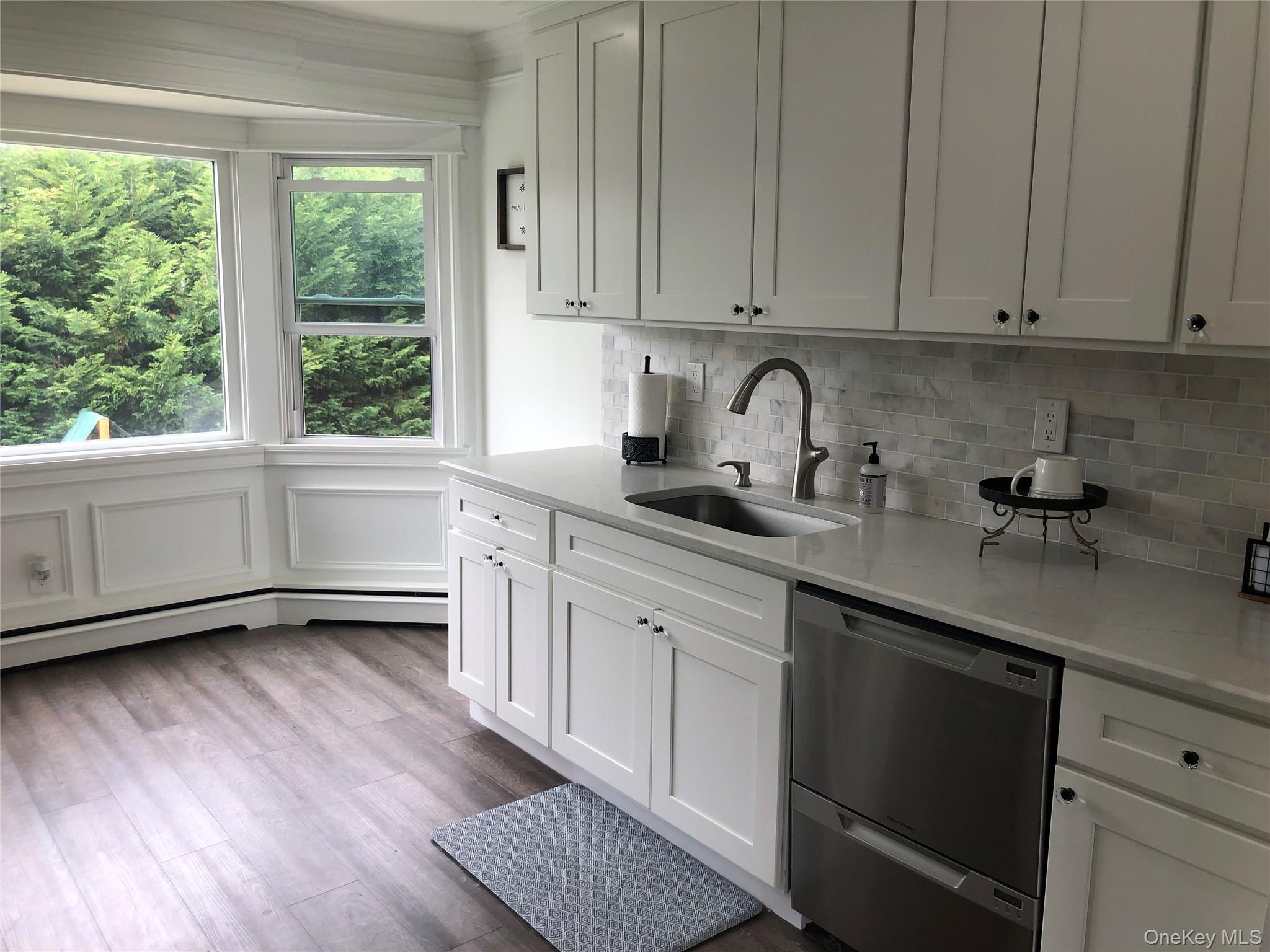 36 Cullen Avenue Islip, NY 11751 - Photo 2 of 16 a kitchen with granite countertop white cabinets and white appliances