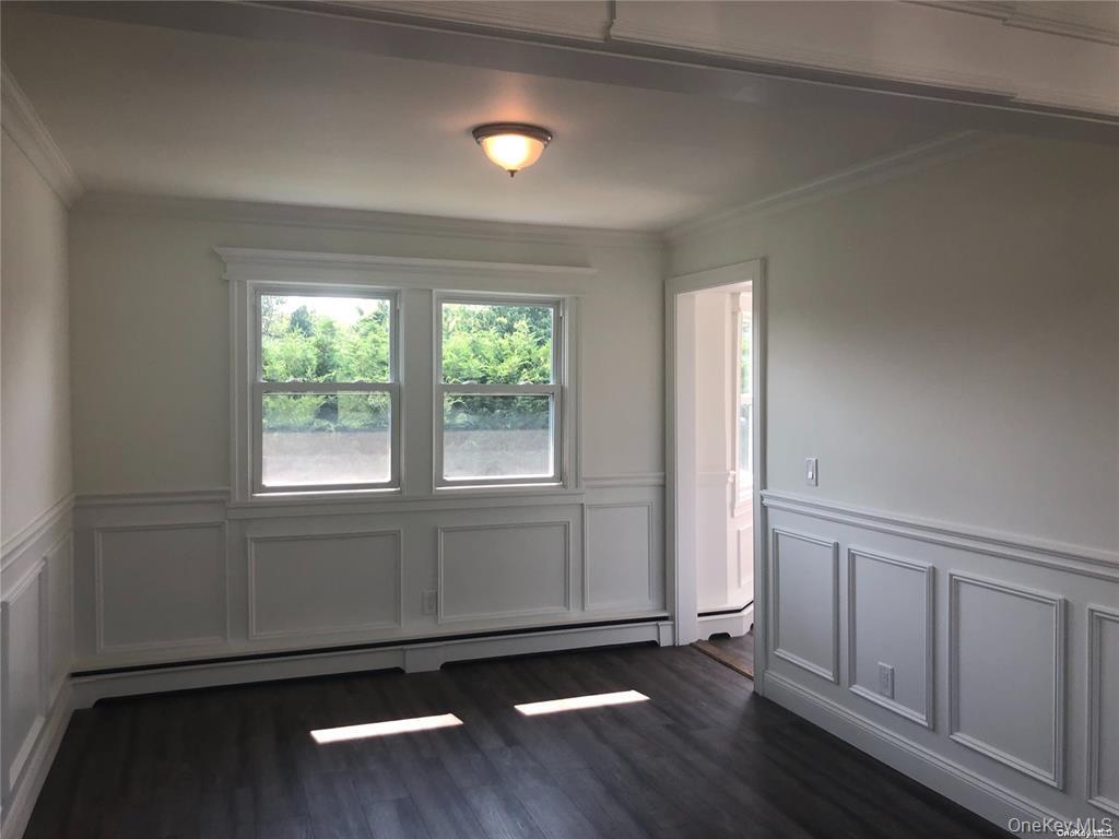 36 Cullen Avenue Islip, NY 11751 - Photo 5 of 16 an empty room with wooden floor and windows
