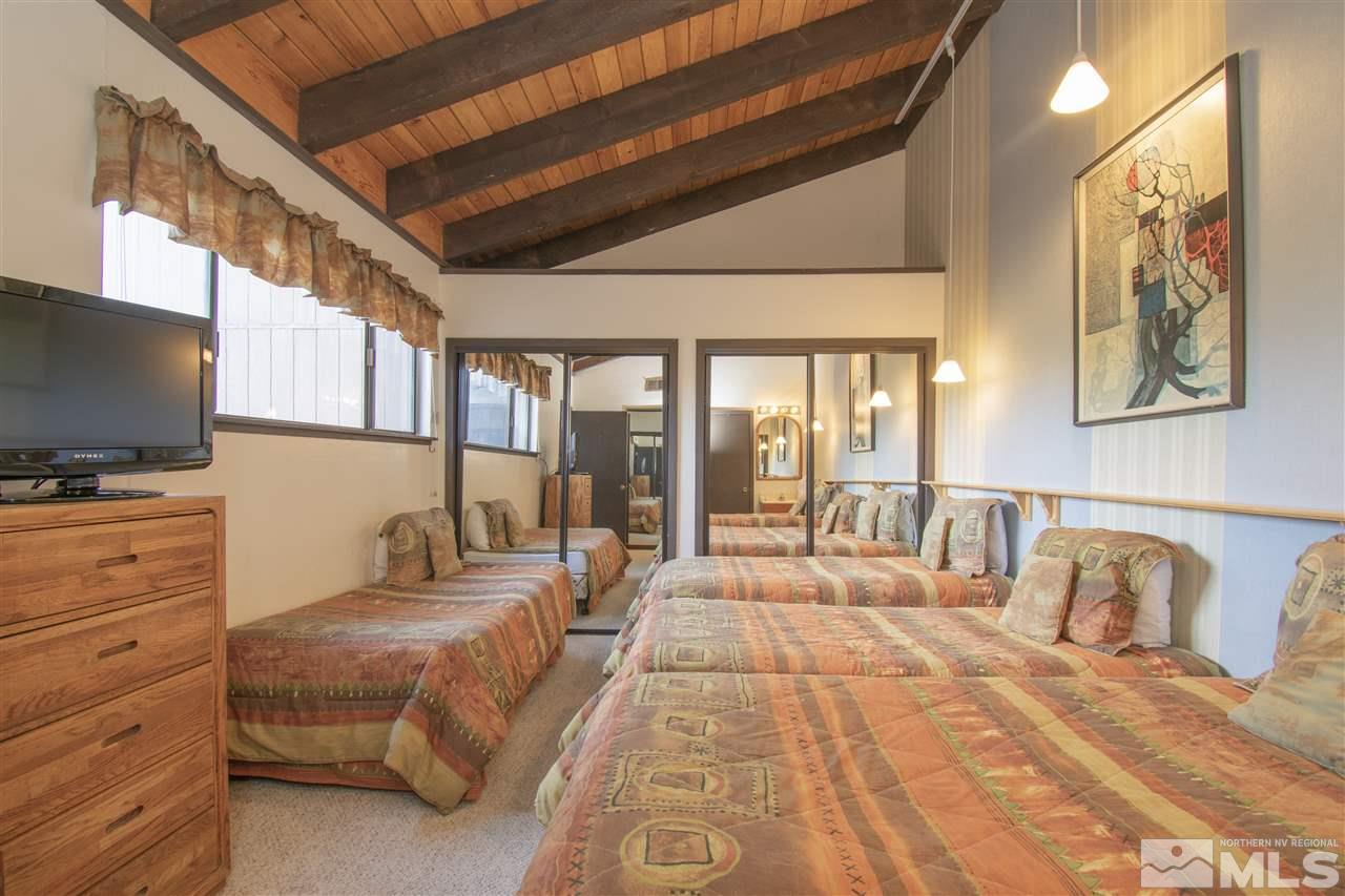 46 Chalet Stateline, NV 89449 - Photo 12 of 18 a spacious bedroom with a large bed and a flat screen tv