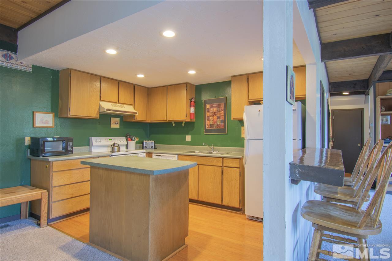 46 Chalet Stateline, NV 89449 - Photo 7 of 18 a kitchen with cabinets and chairs