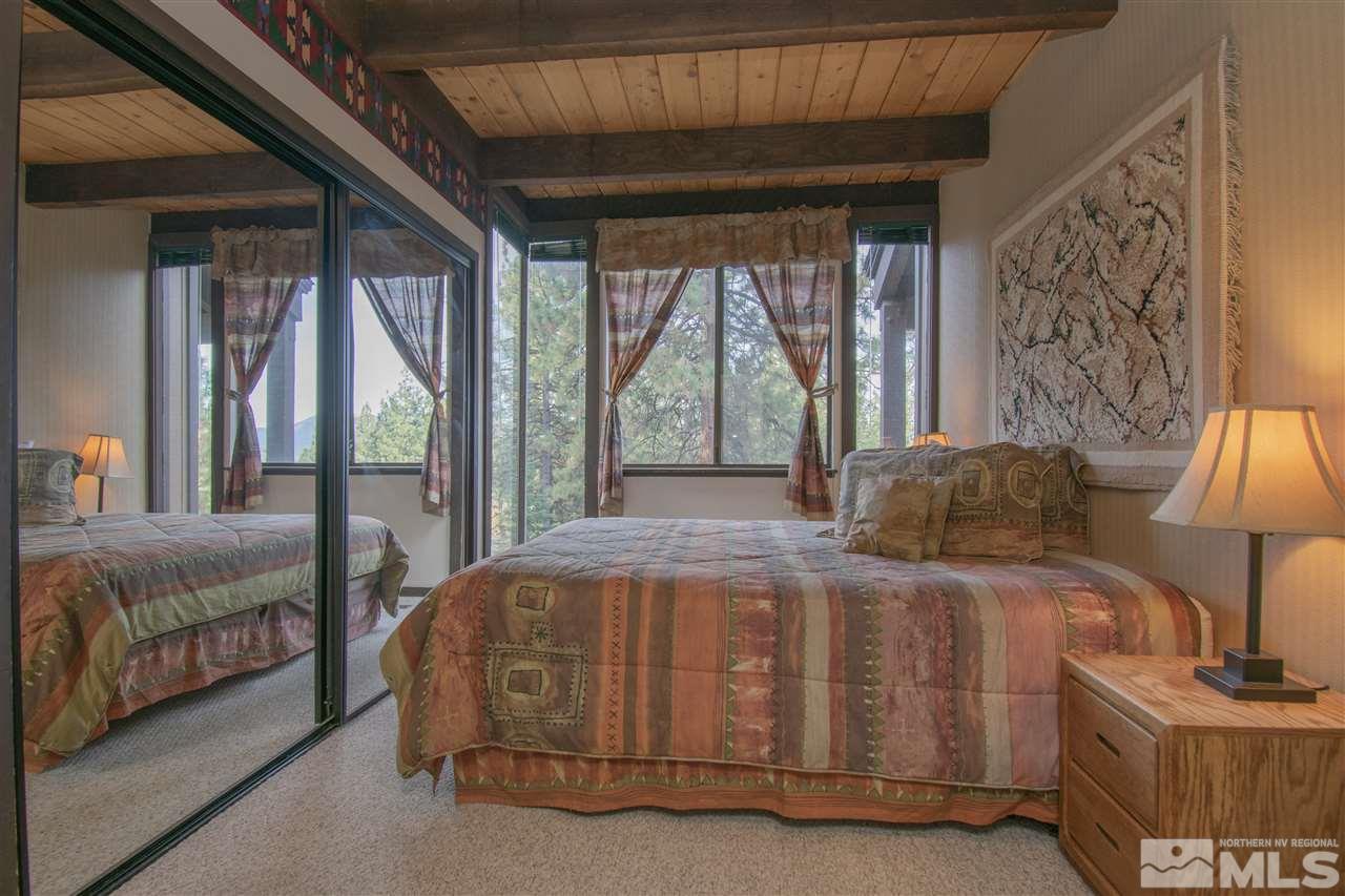 46 Chalet Stateline, NV 89449 - Photo 9 of 18 a bedroom with a bed lamp and window
