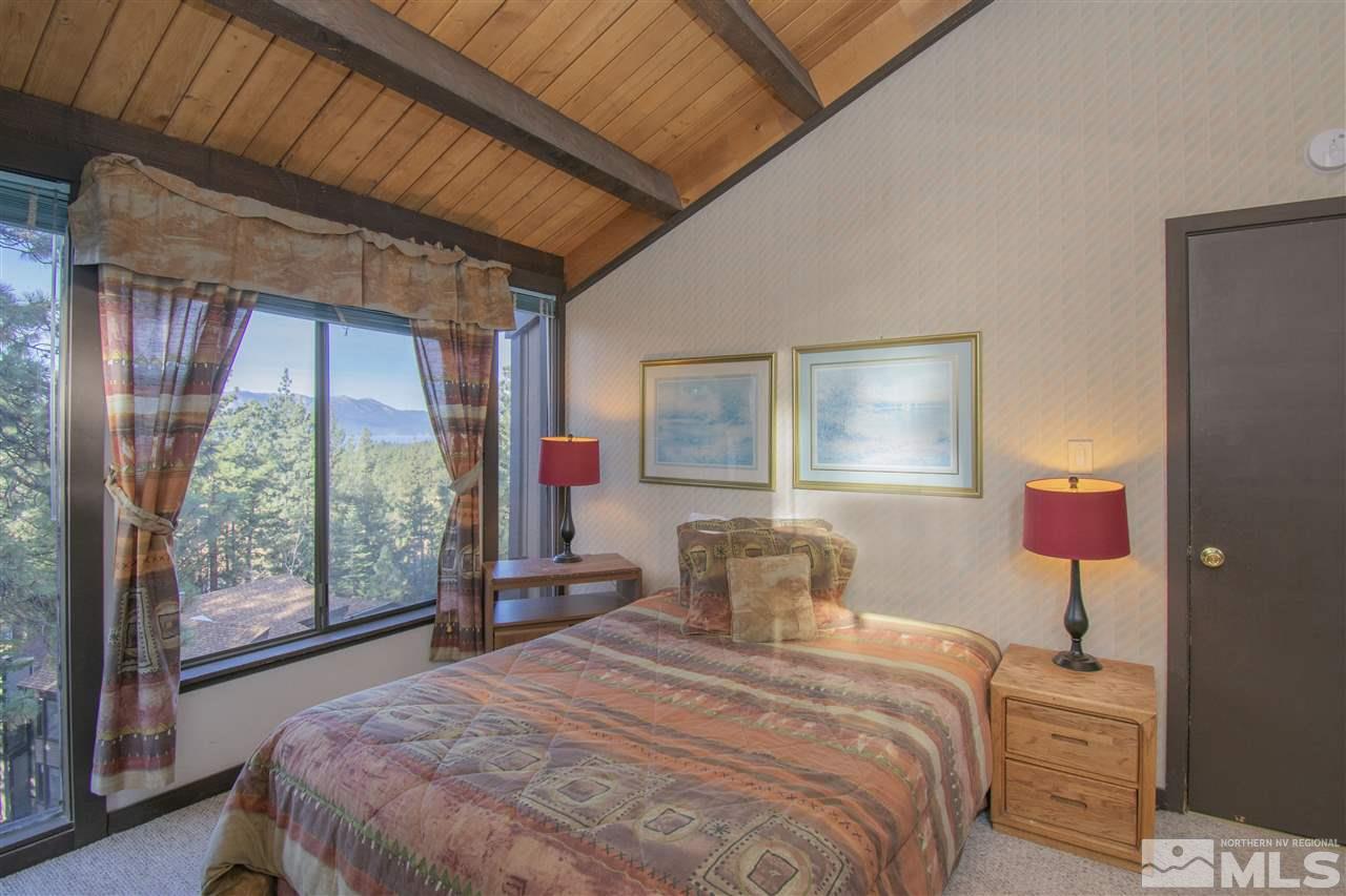 46 Chalet Stateline, NV 89449 - Photo 10 of 18 a bedroom with a bed and wooden floor