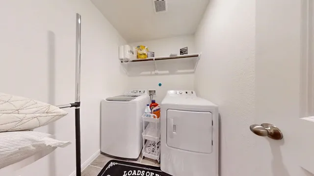 a yellow house with a big yard plants and large trees