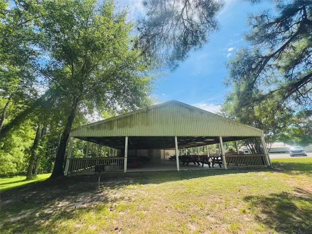 a view of yard with swimming pool and green space