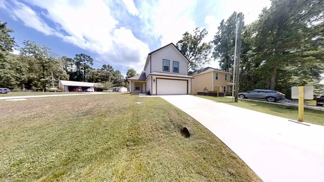 a view of a house with snow on the road