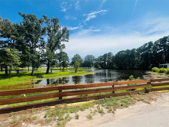 a view of a lake with houses in the back