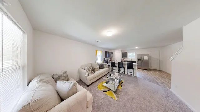 a living room with furniture and a table