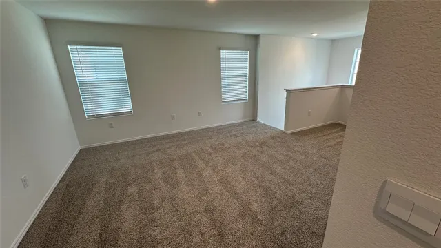 a view of an empty room with windows