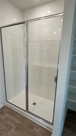 a bathroom with a glass shower door