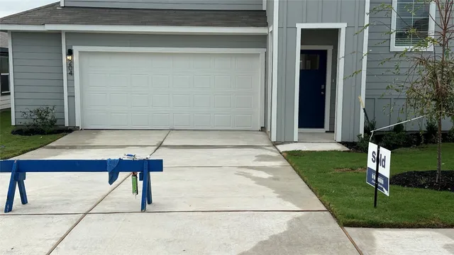 a view of backyard with a table and chairs and potted plants