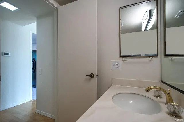 a bathroom with a sink mirror vanity and toilet