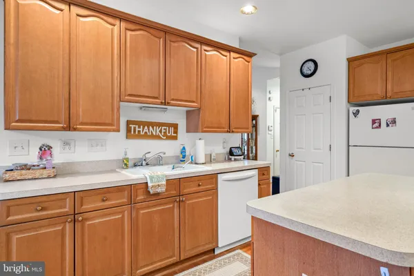 a kitchen with stainless steel appliances granite countertop a refrigerator sink and cabinets