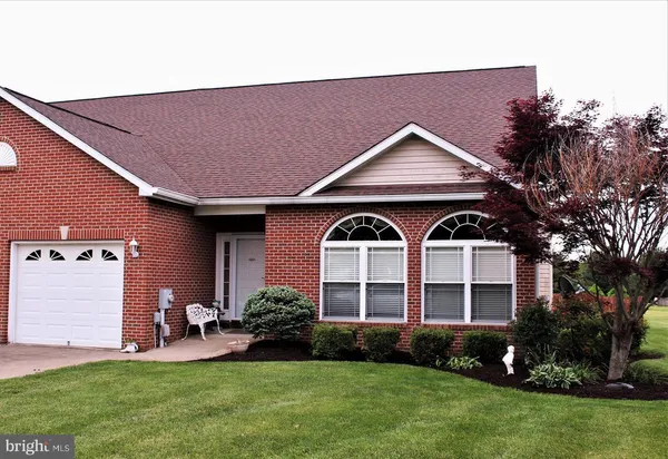 a front view of a house with garden and porch