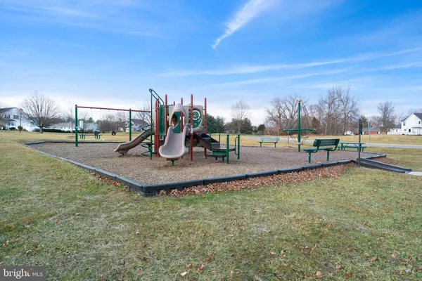 a view of outdoor space with playground and green space