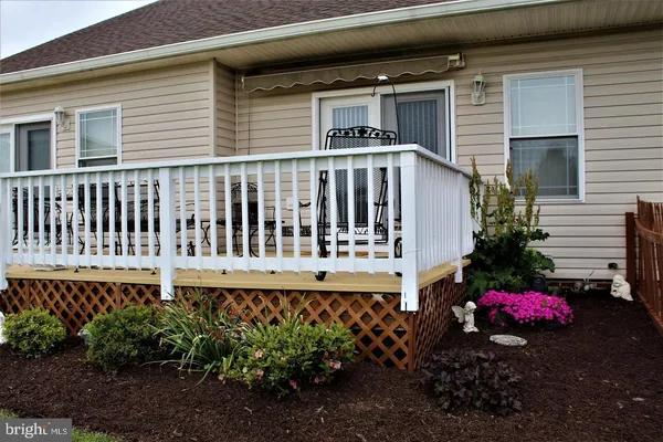 a view of a house with a small yard and plants