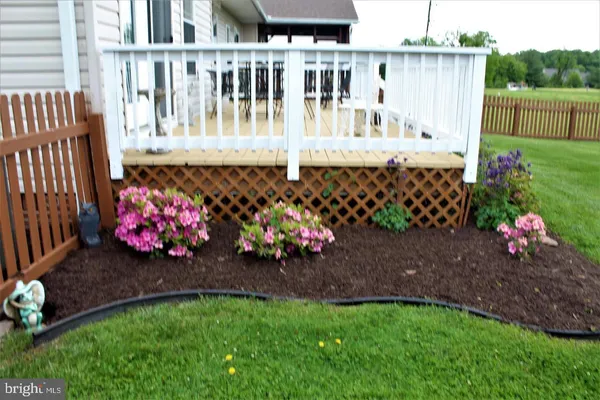 a view of a chair and table in the back yard