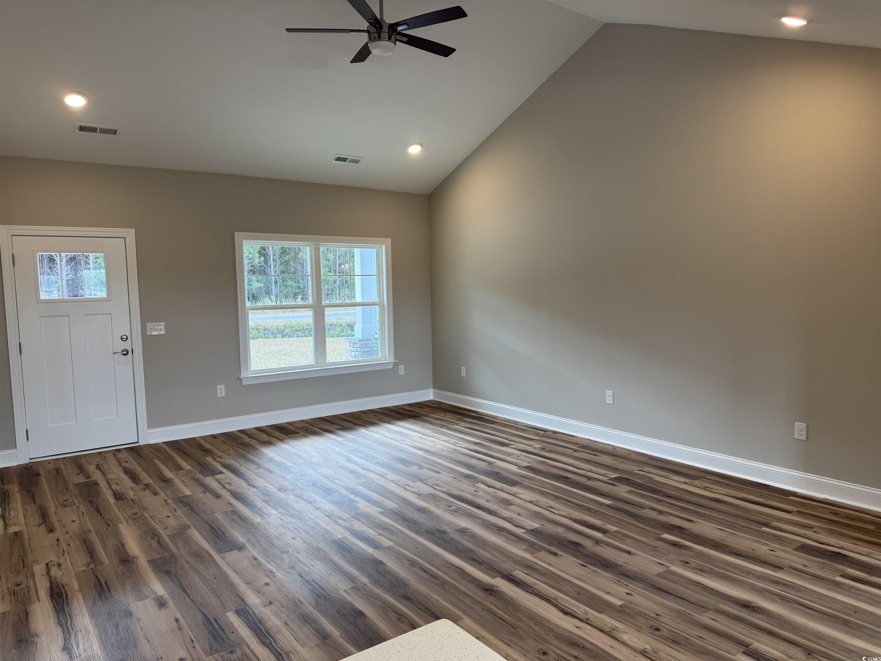 4963 Dupont Road Aynor, SC 29511 - Photo 2 of 18 Unfurnished living room featuring vaulted ceiling, dark wood-style flooring, a ceiling fan, and recessed lighting