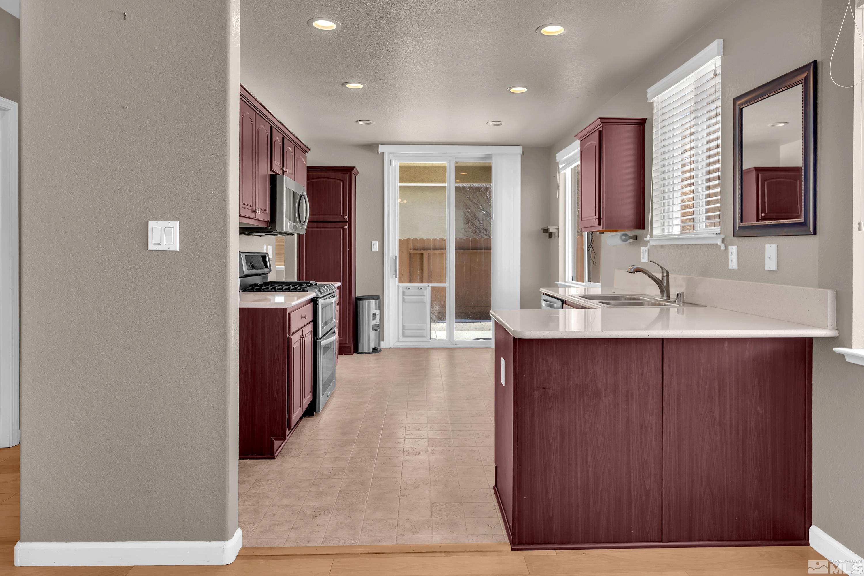 2325 Lincoln Meadows Drive Reno, NV 89521 - Photo 11 of 40 a hall with cabinets a sink and wooden floor