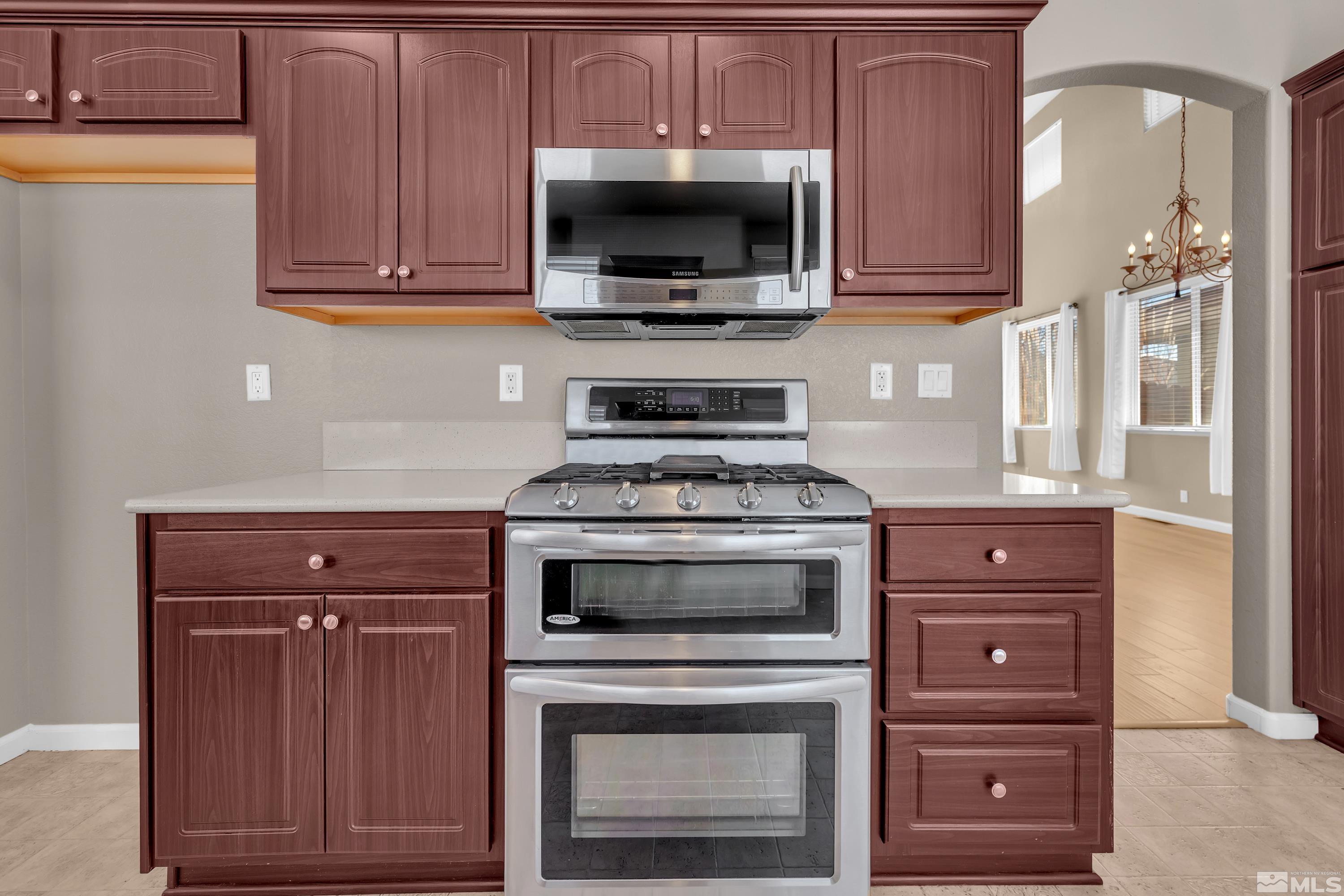 2325 Lincoln Meadows Drive Reno, NV 89521 - Photo 15 of 40 a kitchen with granite countertop wooden cabinets and a stove top oven