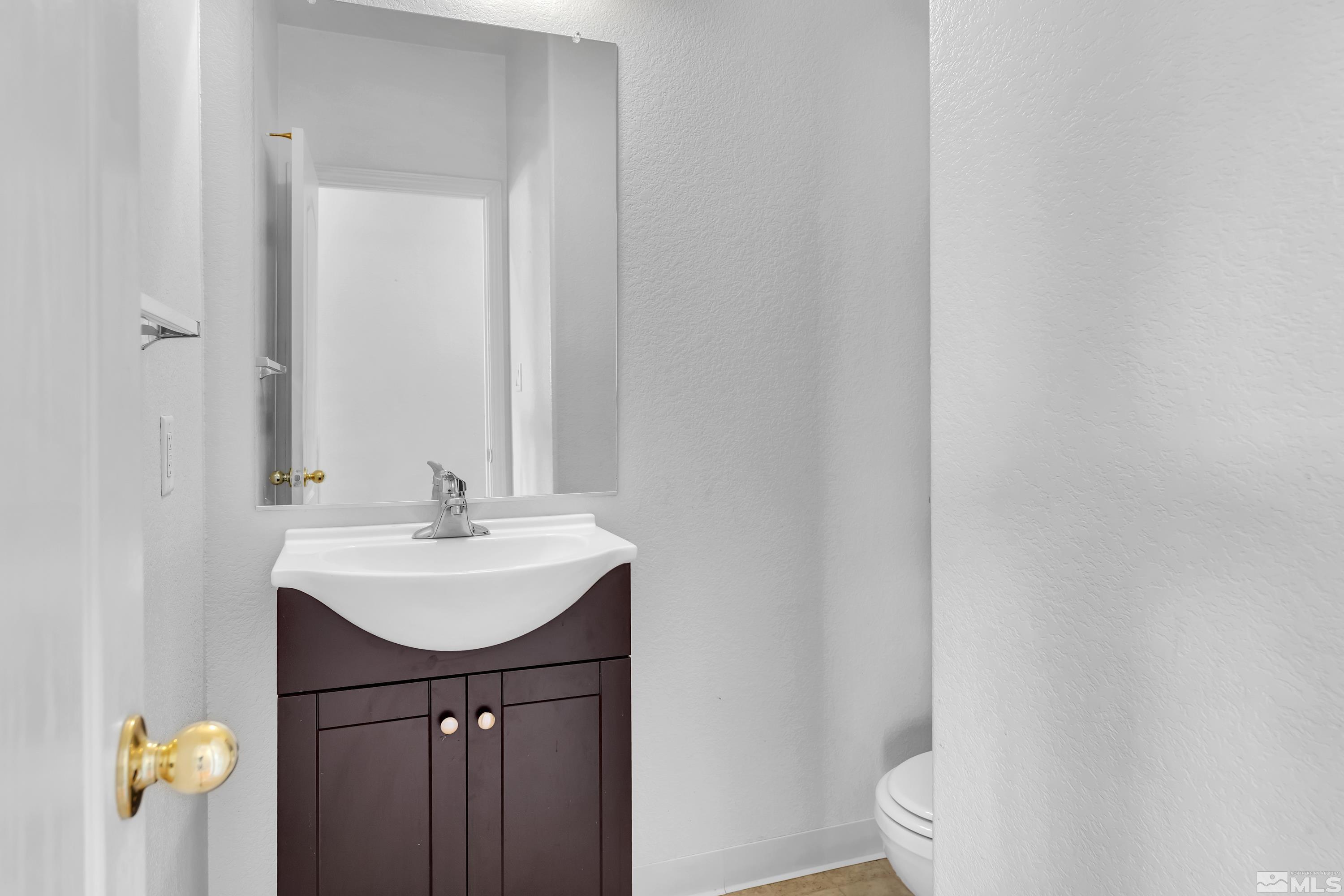 2325 Lincoln Meadows Drive Reno, NV 89521 - Photo 17 of 40 a bathroom with a sink a toilet and mirror