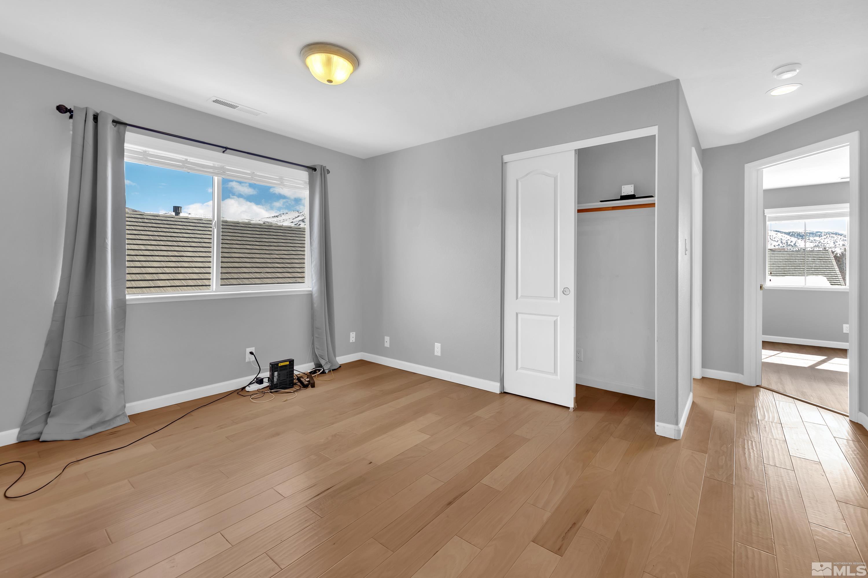 2325 Lincoln Meadows Drive Reno, NV 89521 - Photo 18 of 40 an empty room with wooden floor and windows
