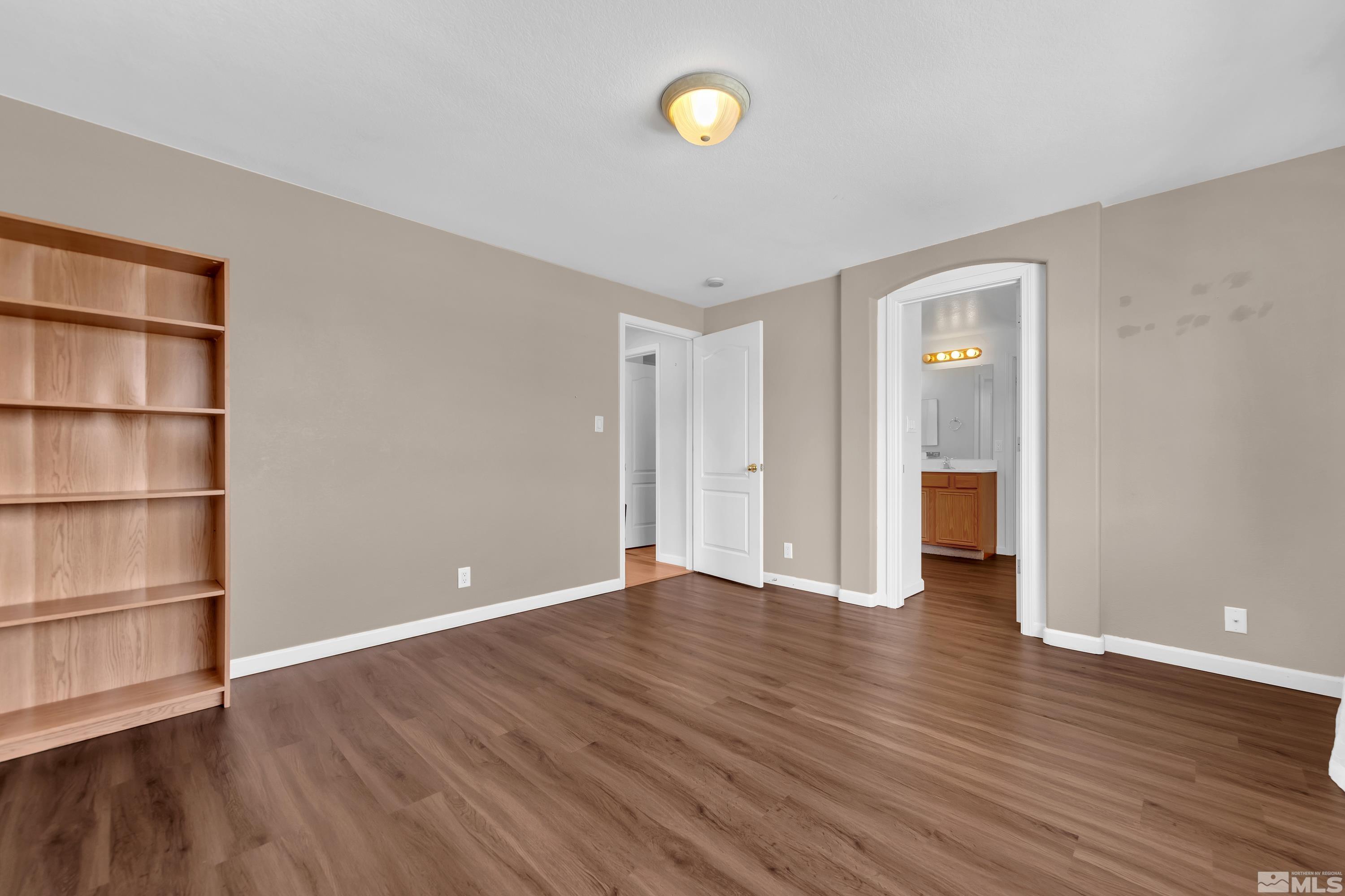 2325 Lincoln Meadows Drive Reno, NV 89521 - Photo 21 of 40 a view of an empty room with wooden floor and window